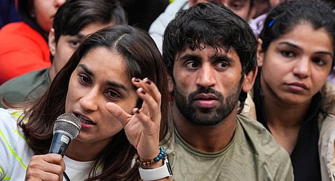 Bajrang Punia, centre, with Vinesh Phogat and Sakshi Malik address a press conference during their protest against WFI chief Brij Bhushan Singh.