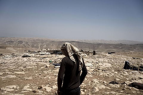 A Palestinian shepherd stands in the ruins of the West Bank Bedouin village of al-Baqa where residents fled in July after settlers established an outpost near the village, Aug. 9, 2023. (Photo | AP)