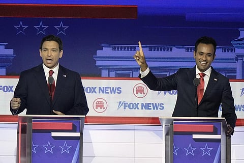 Florida Gov. Ron DeSantis and businessman Vivek Ramaswamy talk at the same time during the GOP presidential primary debate in Milwaukee, Aug 23, 2023. (Photo | AP)