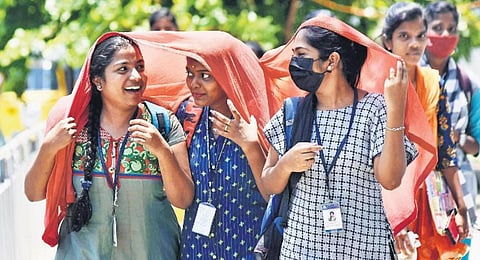 Students cover their faces with a shawl to beat the heat in Chennai | P Jawahar