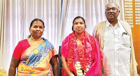 Jeyalakshmi with her father Palanivel and mother after being sworn in as Devikulam block panchayat president on Tuesday. (Photo | Express)
