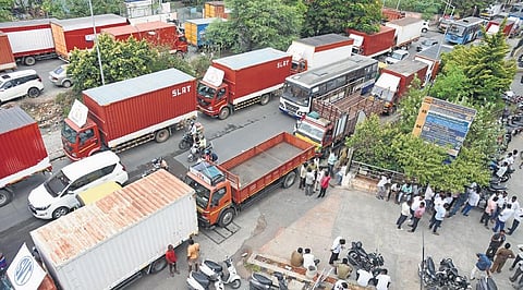 Members of Karnataka State Lorry Owners and Agents’ Association protest by parking their lorries on KH Road, in Bengaluru on Thursday | Vinod Kumar T