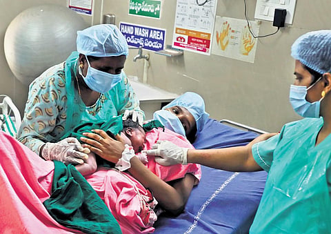 Swaroopa, a midwife from the first batch of the State, helps a newborn breast crawl after conducting the delivery at DH Khammam. (Photo | Sri Loganathan Velmurugan)
