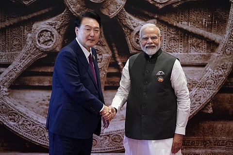 Indian Prime Minister Narendra Modi welcomes Republic of Korea President Yoon Suk Yeol upon his arrival at Bharat Mandapam convention center for the G20 Summit (Photo | AP)