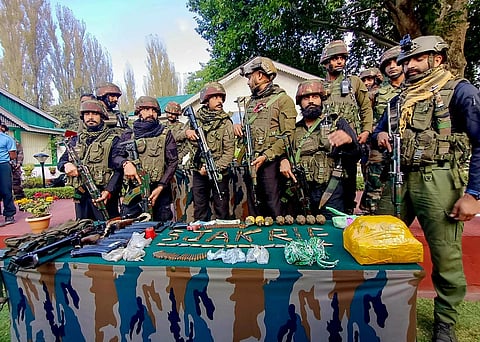 Brigadier PMS Dhillon, Commander 161 Brigade and other Army officials display arms and ammunition recovered from two killed militants, in Hatlanga area of Uri in Baramulla. (PTI)