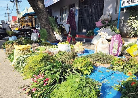 A roadside vendor arranges different varieties of leaves on Sunday. Traditionally, these leaves are offered to Lord Ganesha during the festivities. | VINAY MADAPU