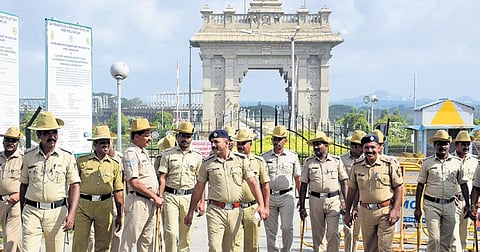Police deployed outside KRS dam on Saturday; A dog joins the protest by carrying an empty pot in Mandya | Udayashankar S