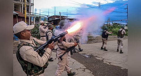 FILE - A policeman fires tear gas at the protesters in Imphal, as they demand restoration of peace in the state after ethnic violence, Sept 21, 2023. (Photo | AFP)