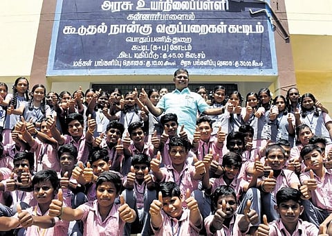 Gnanasekaran with students of Kannarpalayam Government School, Sikkarampalayam, who were taken on tour by flight | S Senbagapandiyan