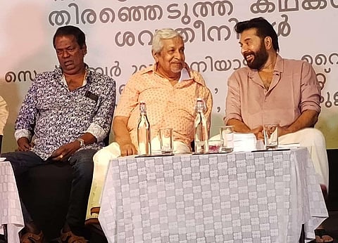 Actors Mammootty and Salim Kumar sharing stage with Professor C R Omanakuttan.