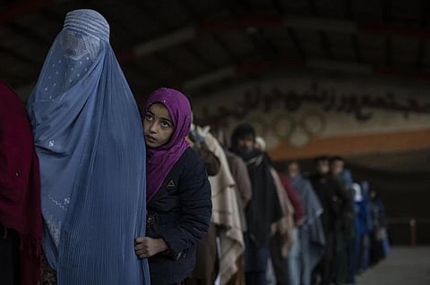 Women queue to receive cash at a money distribution site organized by the World Food Program in Kabul, Afghanistan, on Nov. 20, 2021. (File Photo | AP)