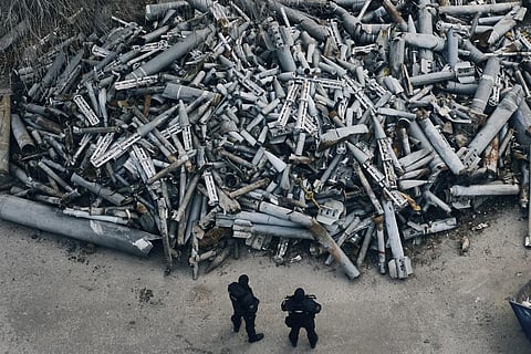 Police officers look at collected fragments of the Russian rockets, including cluster rounds, that hit Kharkiv, in Kharkiv, Ukraine, on Dec. 3, 2022. (Photo | AP)