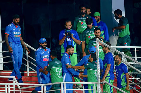 Indian and Pakistani players great each other after their Asia Cup match was called off due to rain, at Pallekele International Cricket Stadium in Sri Lanka on September 2. (Photo | PTI)