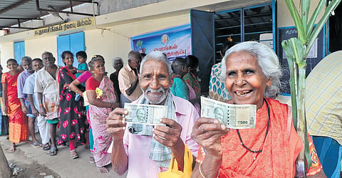 People are seen waiting in a queue to collect Pongal gift with Rs 1000 from a ration shop at Madurai. (Photo | K.K.Sundar)