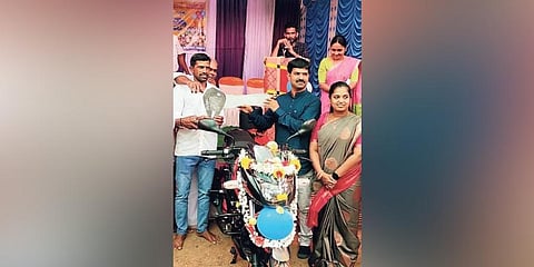  Teacher Santosh Kanchan poses with the bike gifted to him by the residents of Valuru village in Sagar taluk | Express 