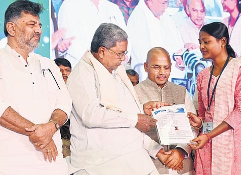 Chief Minister Siddaramaiah, DK Shivakumar and Minister Dr Sharan Prakash Patil during the launch of the Yuva Nidhi scheme in Bengaluru. (Photo | Express)