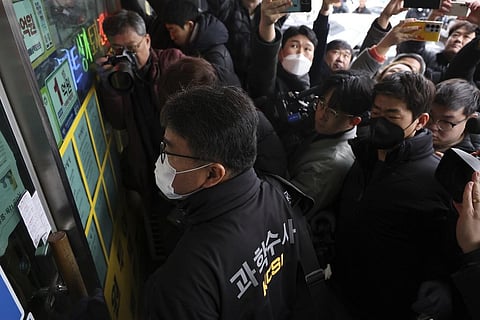 South Korea police arrives for seize materials at the office of the man who stabbed opposition leader Lee Jae-myung. (Photo | AP)