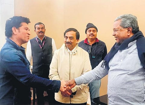 Chief Minister Siddaramaiah greets cricket legend Sachin Tendulkar at the Delhi airport, on Thursday | Express