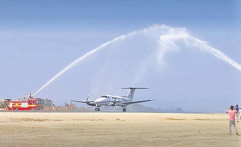 The aircraft receiving a water canon salute at Malkangiri airport | Express