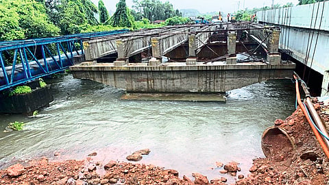 Mapusa : National Highways contractor to construct the bridge without removing soil and stones along with waste construction materials from the Tar river.