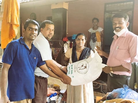 Ashok Naik, President of GMSj, along with other office bearers while helping the flood affected families in Khadki, Goa. On Tuesday, 27 July, 2021.