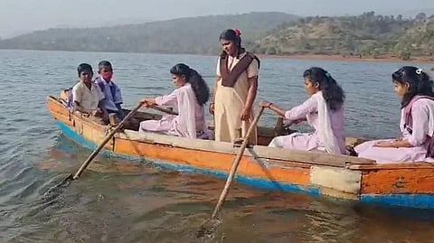 Children cross koyna dam by boat