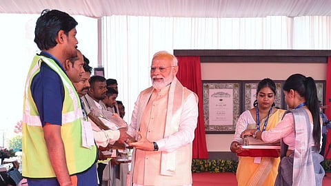 PM Modi felicitates labourers during new Parliament's inauguration ceremony.