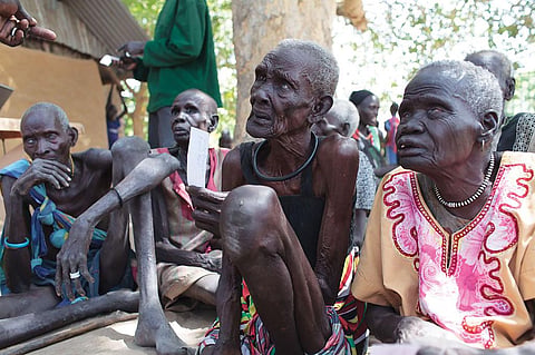 In South Sudan where famine has been declared, elderly women listen to news about possible assistance. Amid the worsening situation, vulnerable people queue up for food distribution programmes. Many of them are old and suffer from ill health. In Nyal, Panyijar County, people take the help of canoes to reach food camps for registration (Credit: Bruno Bierrenbach Feder/Oxfam)