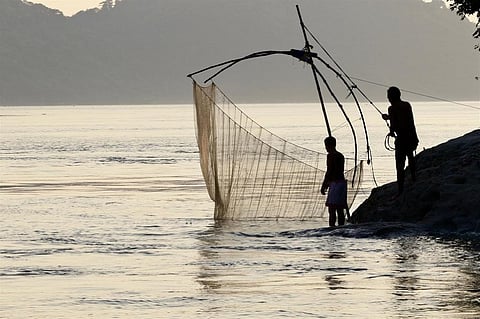 Fishermen on the Brahmaputra, a river that winds through four countries. Credit: Sumit Vij