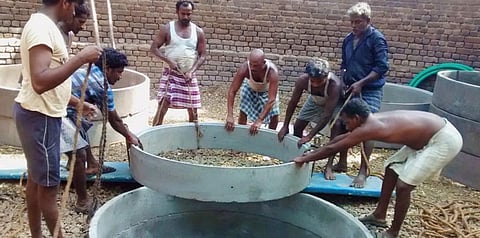 Constructing a rain-harvesting structure in India. Credit: Sekhar Raghavan
