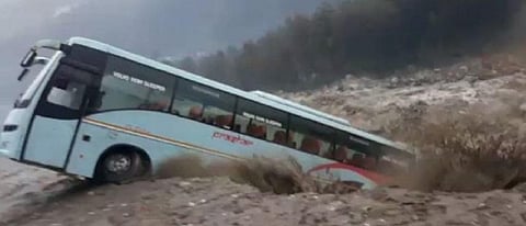 A screenshot from a video of a Volvo bus being swept away by the flooded Beas River in Manali. Credit: Twitter