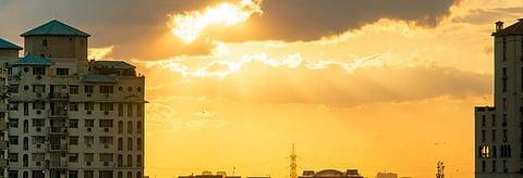 The sun sets over Gurugram. Credit: Getty Images