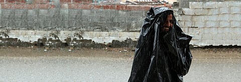 A Jeddah resident photographed during heavy rainfall in the city during 2011. Credit: Flickr