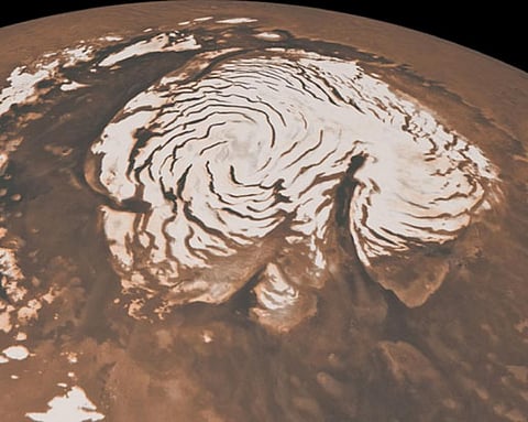 This image, combining data from two instruments aboard NASA’s Mars Global Surveyor, depicts an orbital view of the north polar region of Mars. Photo: NASA/JPL-Caltech/MSSS