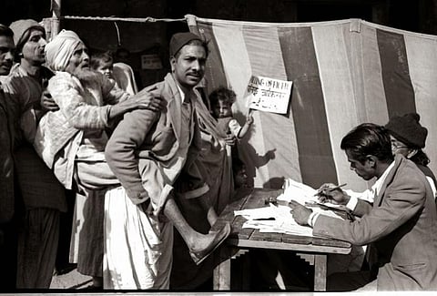 A man carries his visually challenged man to a polling booth in Jama Masjid area in Delhi during the 1951 Lok Sabha elections. Photo: Wikimedia Commons