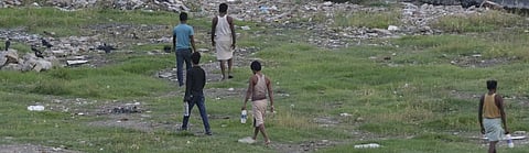 Men going out to defecate in the open. Photo: Vikas Choudhary