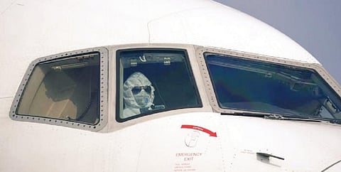 A pilot leaving China in a full protective suit and a face mask. Photo: @Aviationdailyy / Twitter