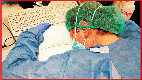 A nurse rests during a night shift at a hospital in Cremona, Italy