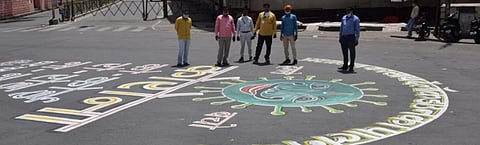 People pose next to a mural of the novel coronavirus (SARS-CoV-2) in Bundelkhand Photo: Arindam Ghosh
