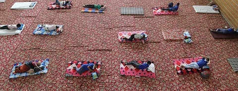 Homeless people take refuge at Yamuna sports complex during the nationwide lockdown, in New Delhi. Photo: Vikas Choudhary