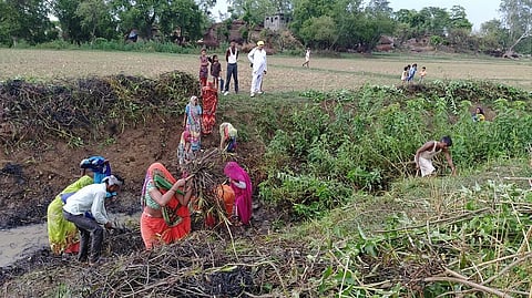 उत्तर प्रदेश के बांदा जिले के गांव भावंरपुर लौटे प्रवासी श्रमिक लुप्त हो चुकी घरार नदी की सफाई करते हुए। फोटो: अनिल सिंदूर