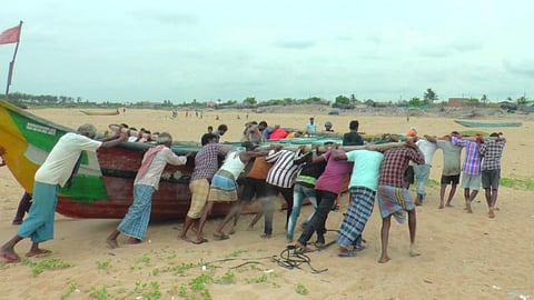 Fishermen in Paradip take their fishing boat to a safer place fearing Cyclone Yaas. Photo: Ashis Senapati