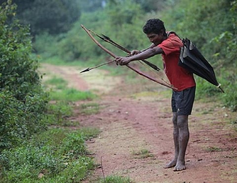 A Bonda tribesman in Odisha hunts with his bow and arrows. Photo: Vikas Choudhary / CSE