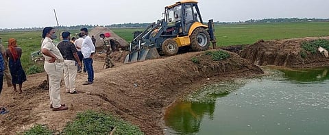 Officials demolishing illegal prawn farms in Dibakarpur village. Photo: Ashis Senapati