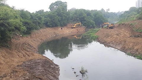 Earth-movers clear vegetation on the flood plain of the Vishwamitri river in Vadodara