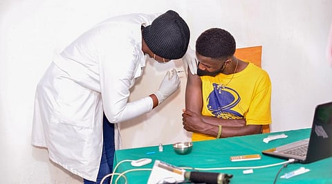 A Rwandan youth gets vaccinated against COVID-19 in Kigali. Photo: Davyimage via Wikimedia Commons