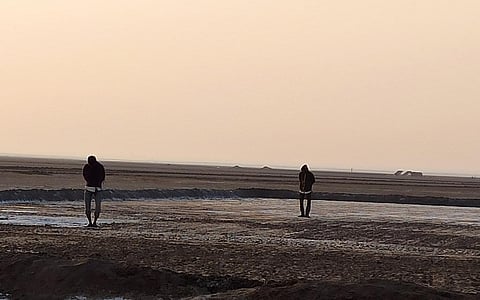 Workers preparing the crystaliser pan with bare feet. Photo: Ravleen Kaur