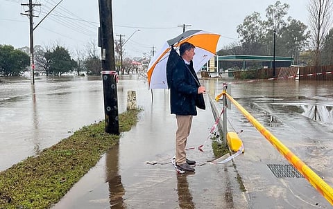 Photo: Australian MP Angus Taylor assesses flood damages in southwest Sydney. @AngusTaylorMP / Twitter