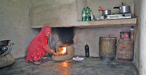 Munni Kinha from Gothda village in Haryana's Bhiwani district uses cow dung and firewood for bulk of the cooking, and LPG only for making tea and chapatis (Photograph: Sunny Gautam)