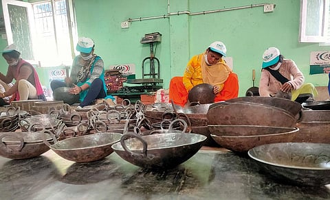 Members of the Purnagiri self-help group in Lohaghat, Uttarakhand, carve iron utensils (Photo: Varsha Singh)